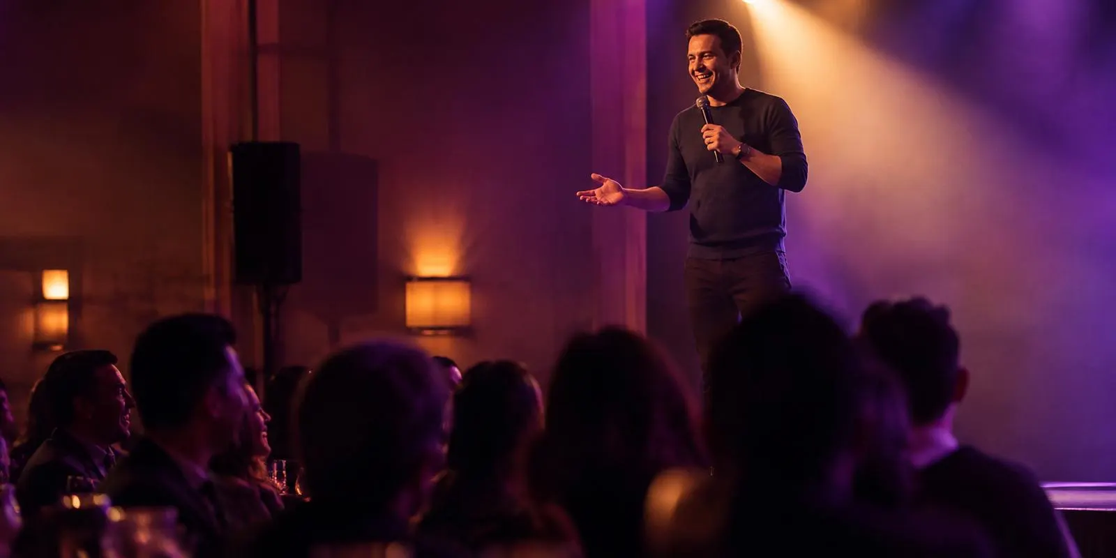 Comedian mid-joke on a portable stage while the crowd laughs