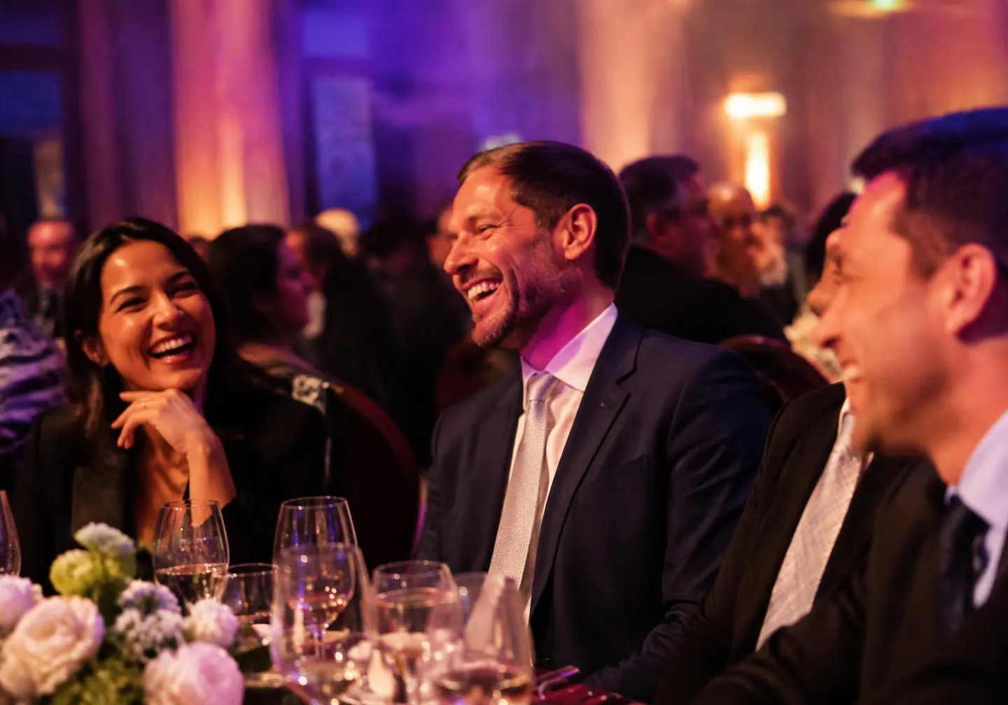 Guests at a banquet table laughing